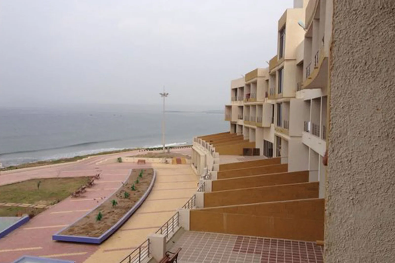 Paved walkway running along the sea side of Sagar Darshan Guest House